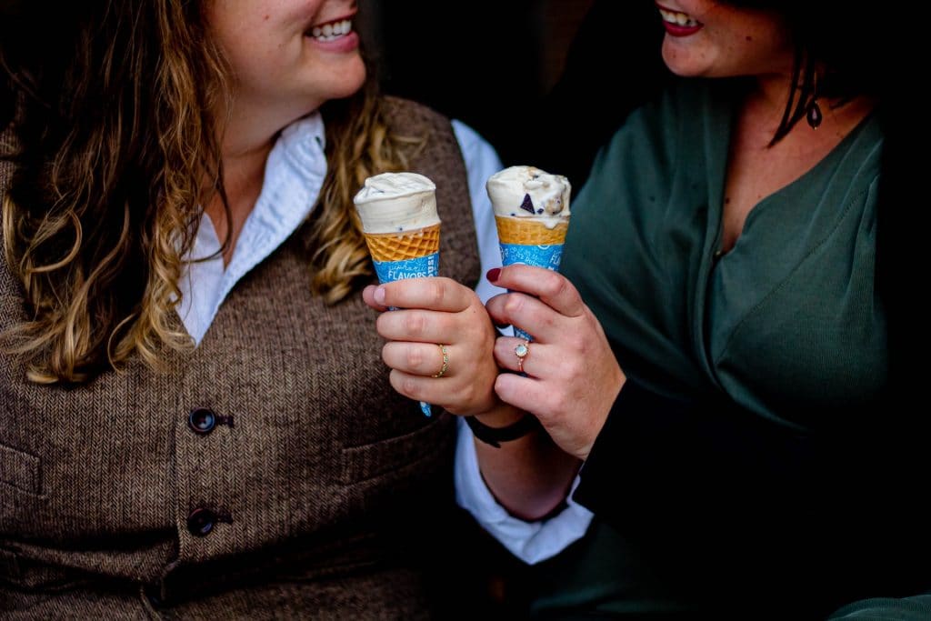 two people holding ice creams is a sign of eating too much unhealthy sugar