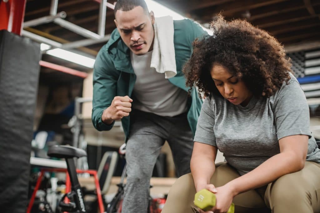 a girl sitting in a gym tired is one of the side effects of sugar